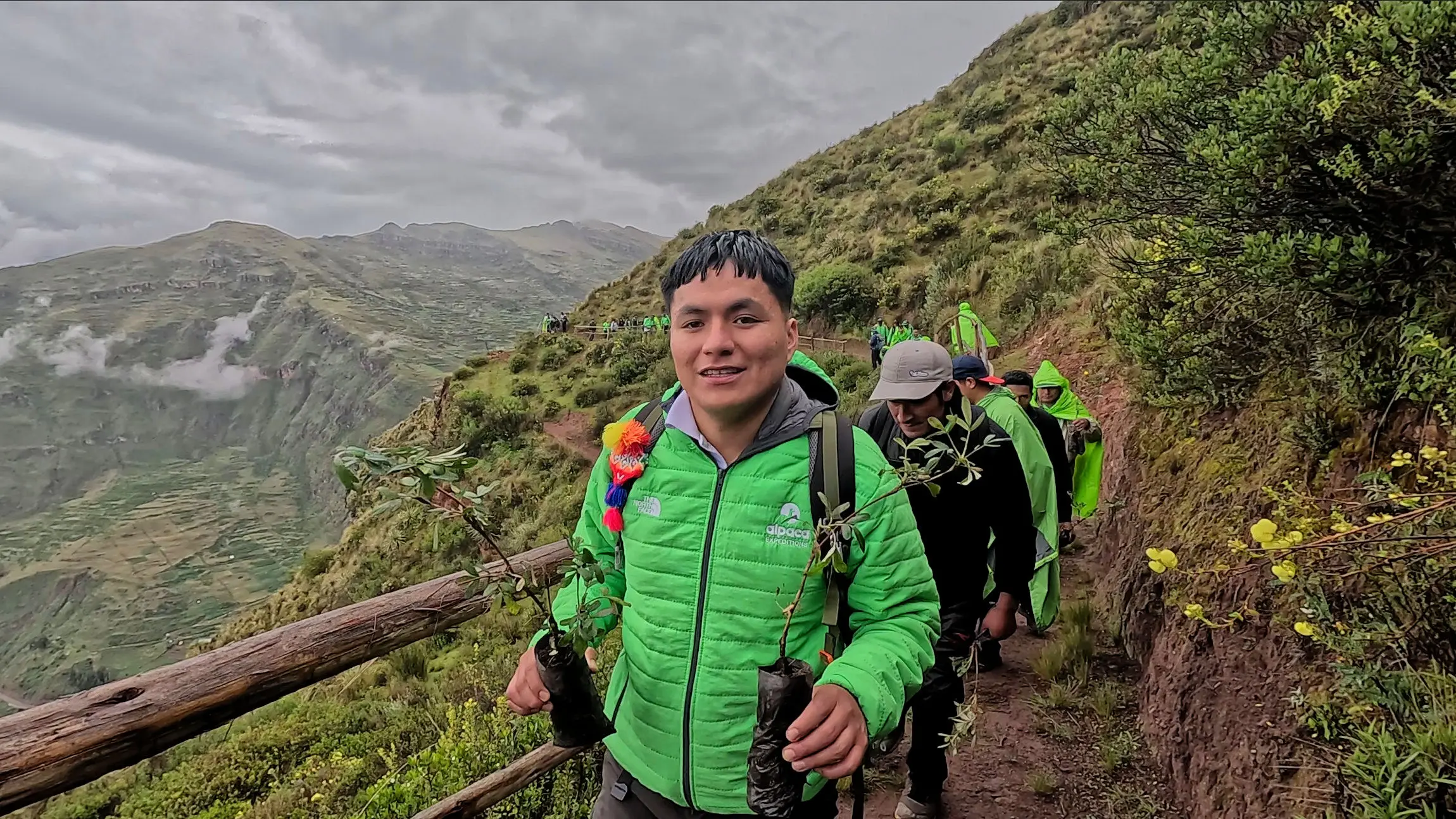 Alpaca Expeditions guide walking along an Andean trail on the way to the reforestation area in Ccaccaccollo.