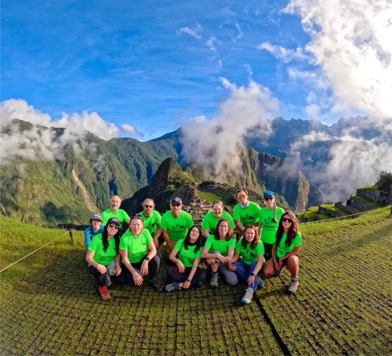 Group of travelers at Machu Picchu at sunrise, Peru