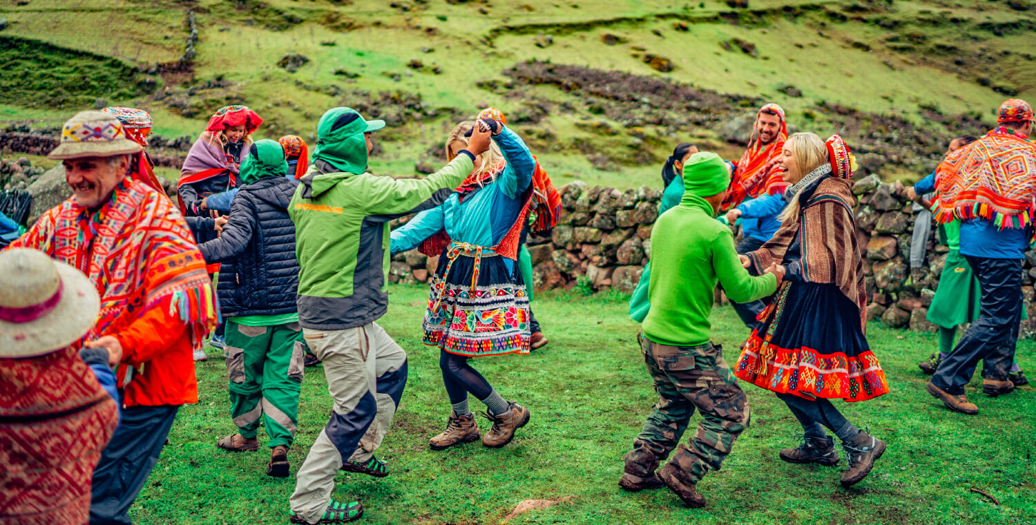 People dancing in traditional Peruvian clothing on the Lares Trek