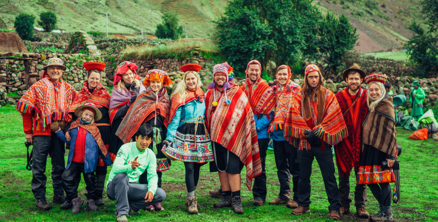 Group Posing in traditional ponchos on the Lares Trek to Machu Picchu