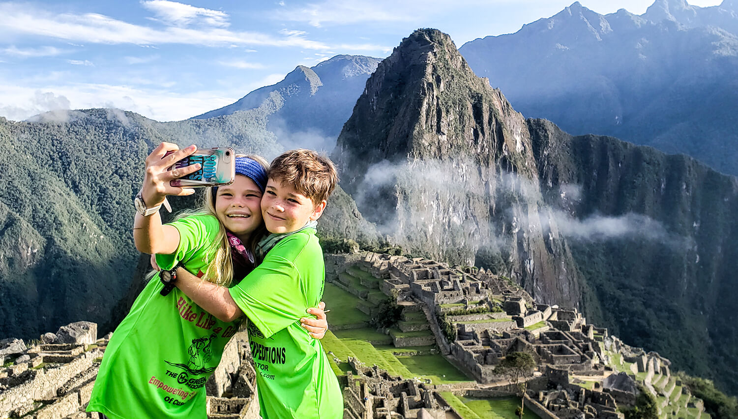 Kids taking a photo in Machu Picchu on 2-day Inca Trail hike