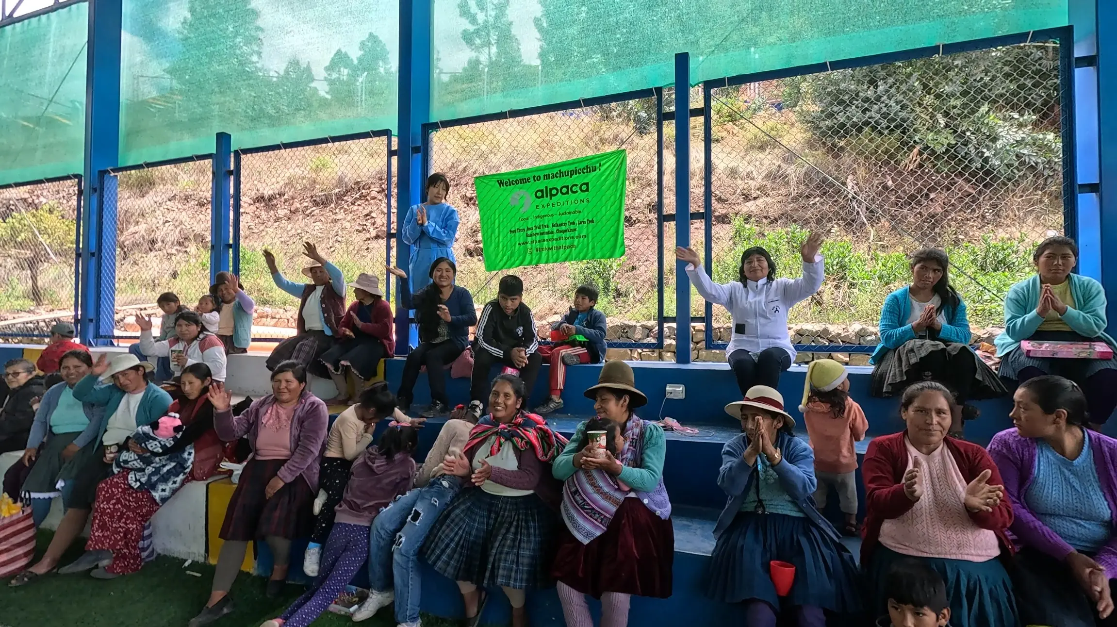 Group photo of Alpaca Expeditions team and children during the Christmas social project in Mitmac.
