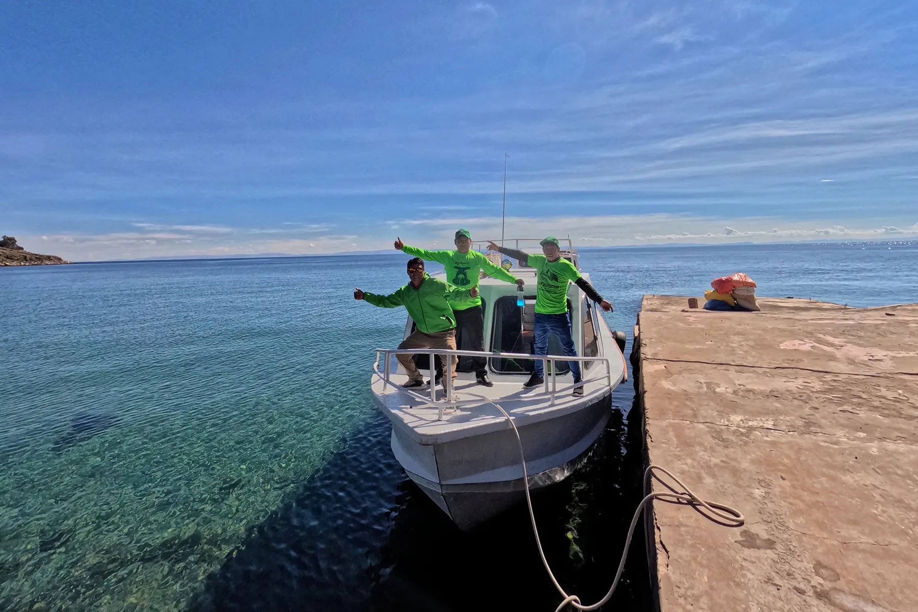 Alpaca Expeditions porters arriving by boat to one of the islands of Lake Titicaca.
