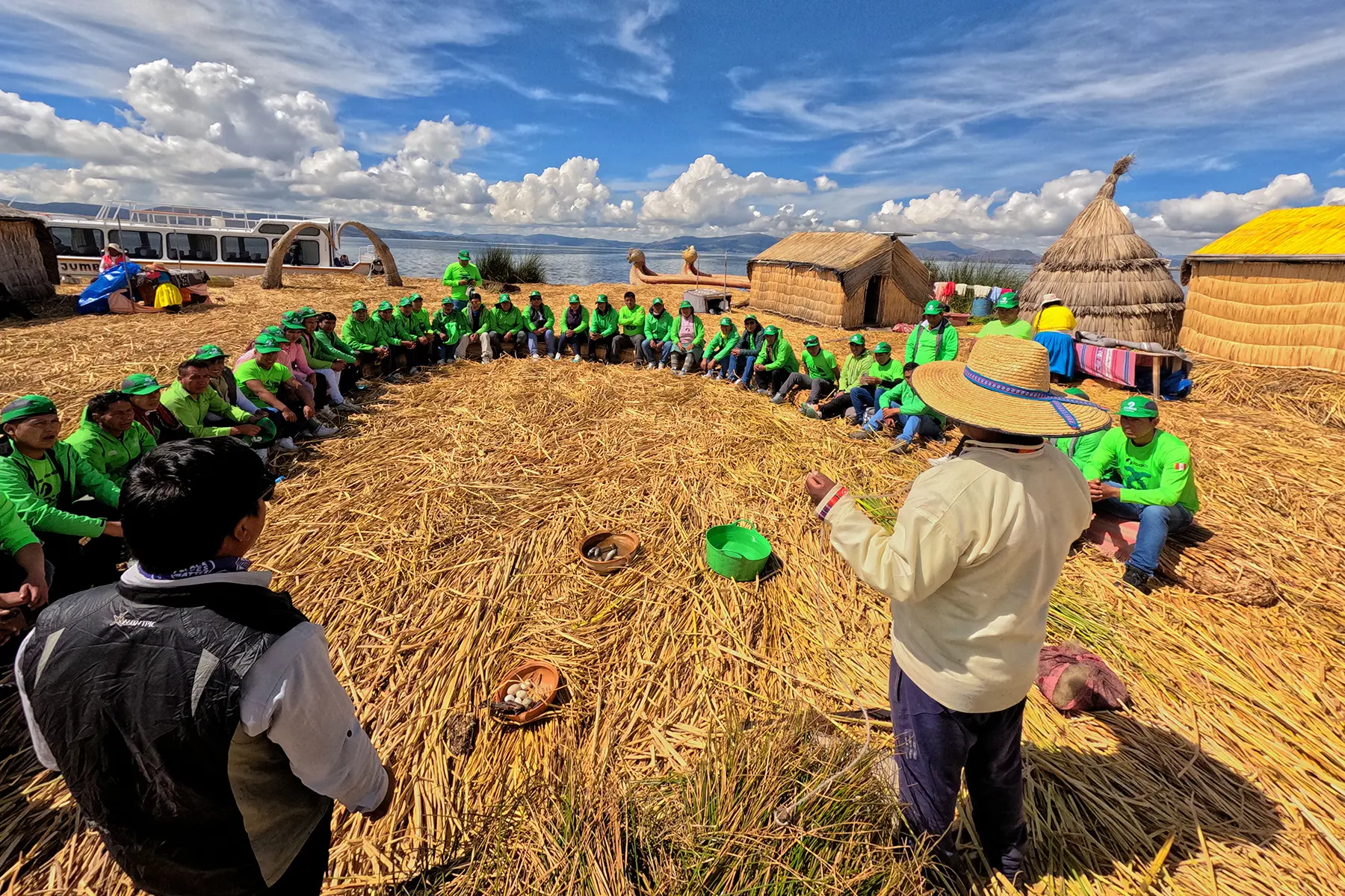 Porters learning about traditional reed houses on the Uros floating islands at Lake Titicaca.