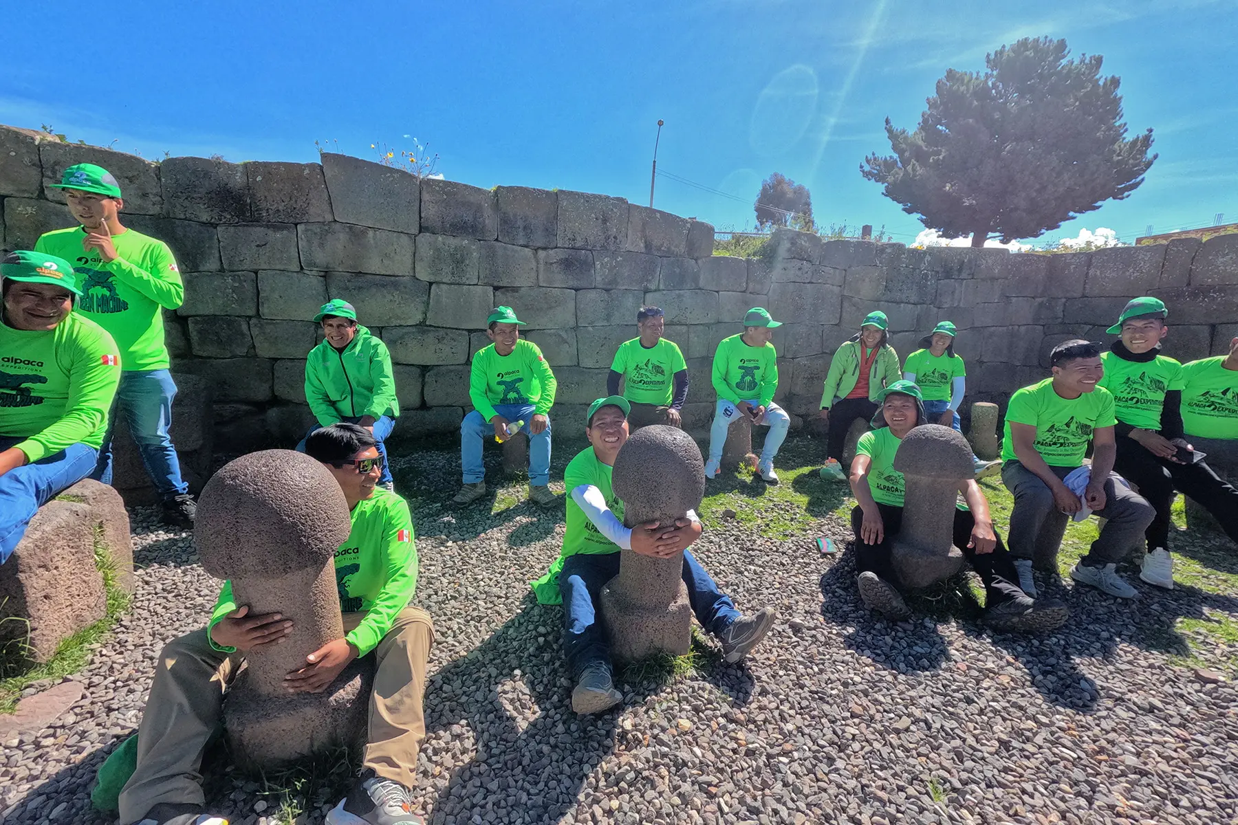 Green Machine porters visiting an archaeological site near Lake Titicaca during their vacation trip.