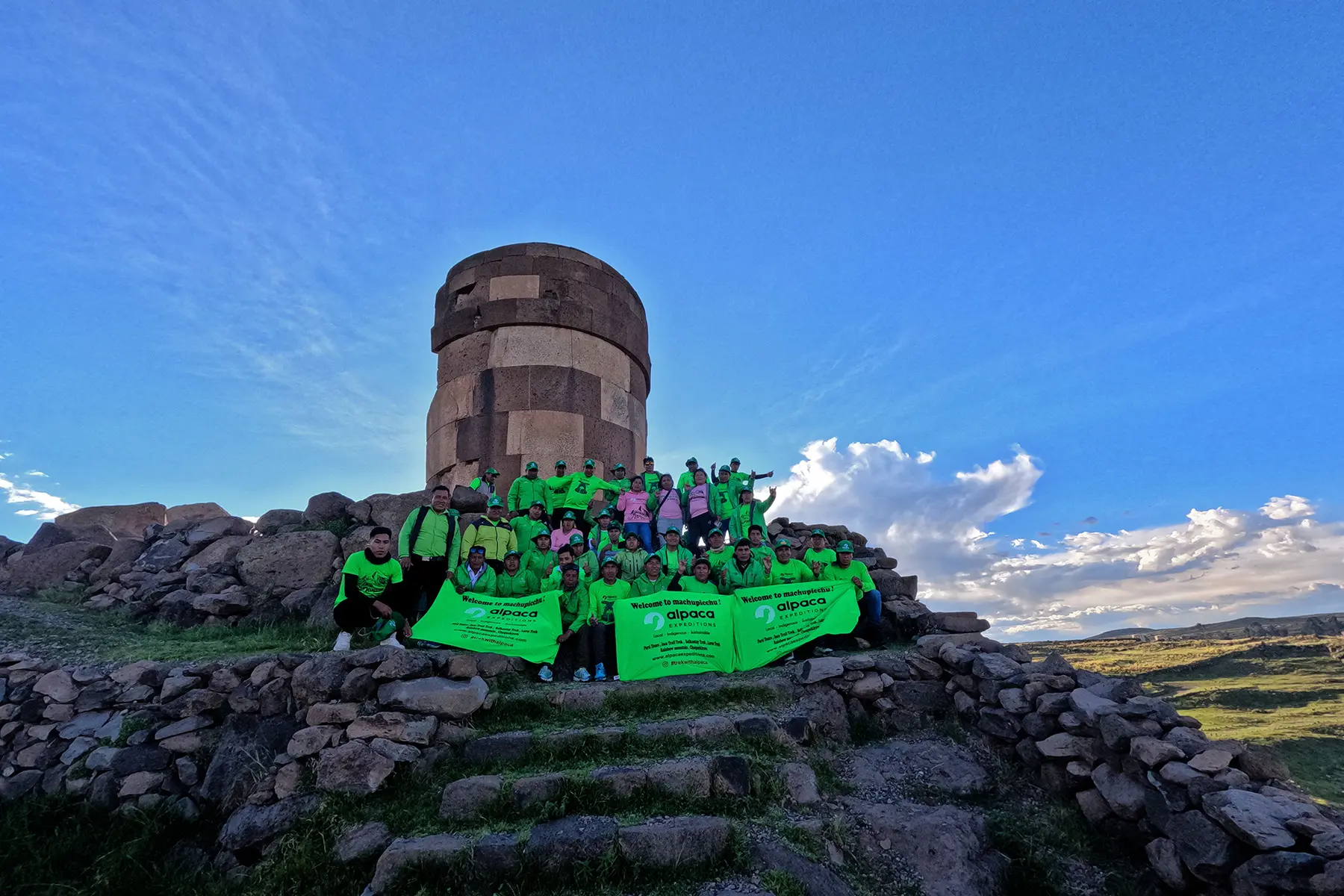 Green Machine team posing together at the Sillustani archaeological site during their vacation.
